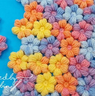 Crochet Puff Little Flowers Featured - The world of crochet is abundant with beautiful designs, but one that stands out for its charm and simplicity is the crochet puff little flower.