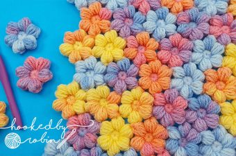 Crochet Puff Little Flowers Featured - The world of crochet is abundant with beautiful designs, but one that stands out for its charm and simplicity is the crochet puff little flower.