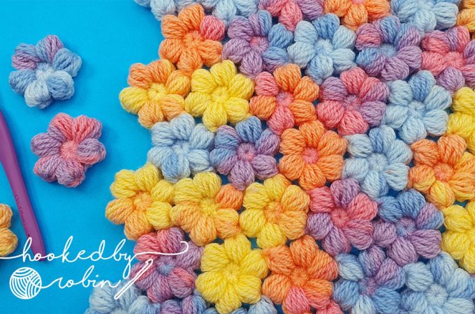 Crochet Puff Little Flowers Featured - The world of crochet is abundant with beautiful designs, but one that stands out for its charm and simplicity is the crochet puff little flower.